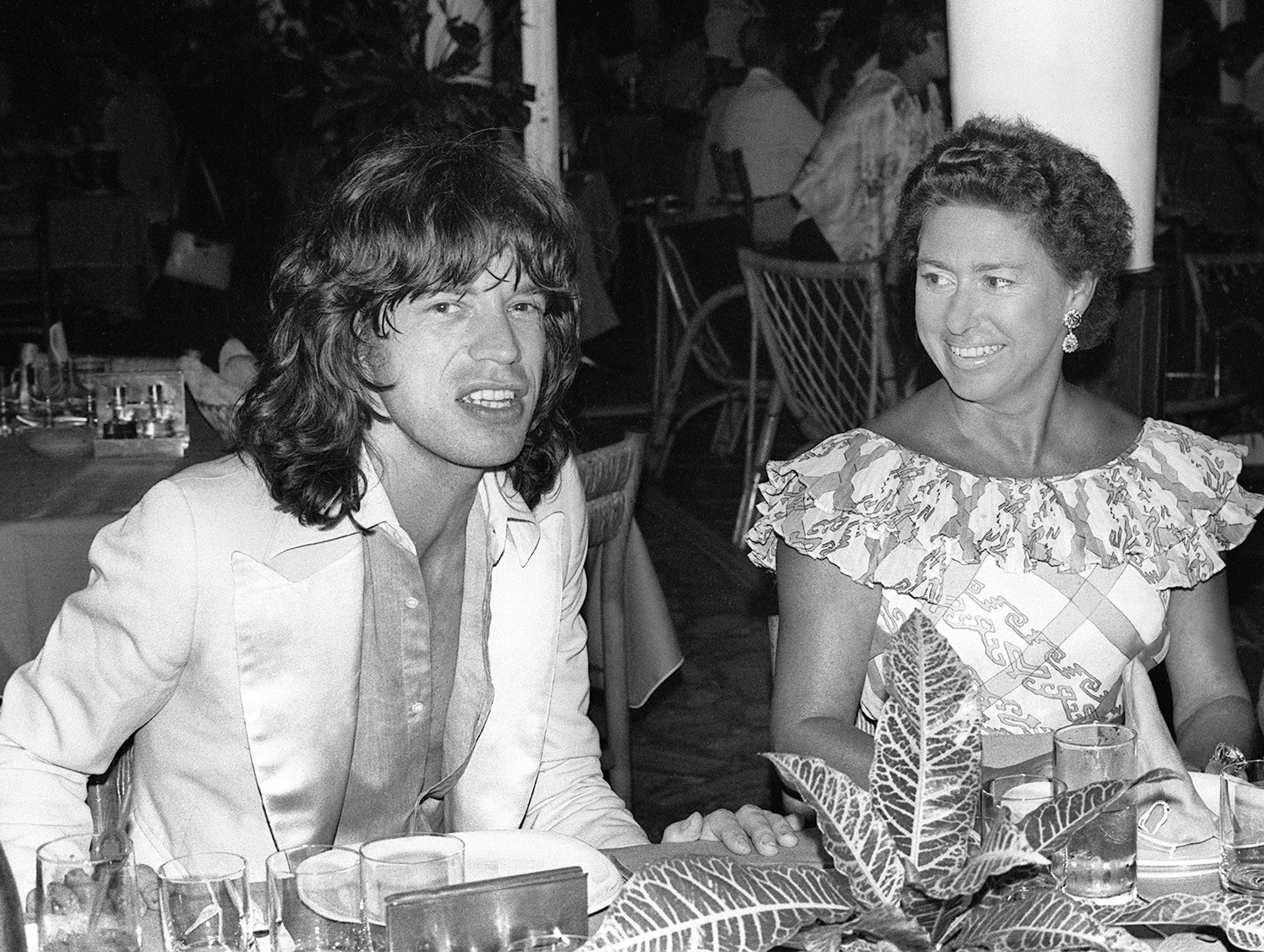 She chats with Rolling Stones star Mick Jagger in a restaurant in 1976